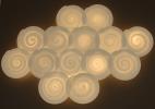 Thrown lit porcelain wall disks.