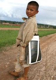 A kid carrying portable light kit on his way